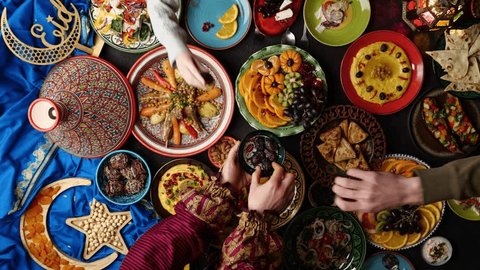 Ramadan family dinner. Breaking Fast with Dates. Iftar in the month of Ramadan is a food that Muslims eat after sunset. Arabic Middle Eastern traditional cuisine Stockvideó