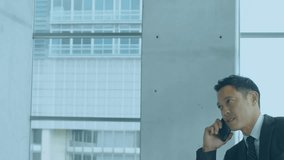 Animation of stock market data processing over asian businessman talking on smartphone at office. Global economy and business technology concept - Powered by Shutterstock - Get 15% off with code: PIKWIZARD15