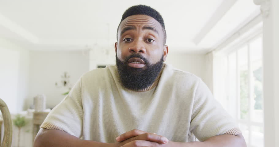 Happy african american man having video call, in slow motion. Spending quality time, domestic life and childhood concept.