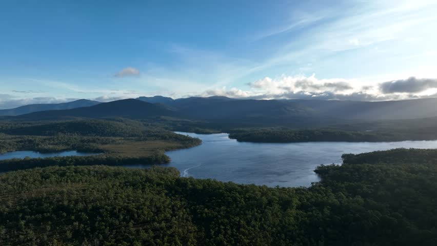 flying over a yacht over a lake in the wilderness with no people