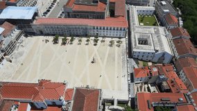 A camera drone flies sidewise over the University of Coimbra campus