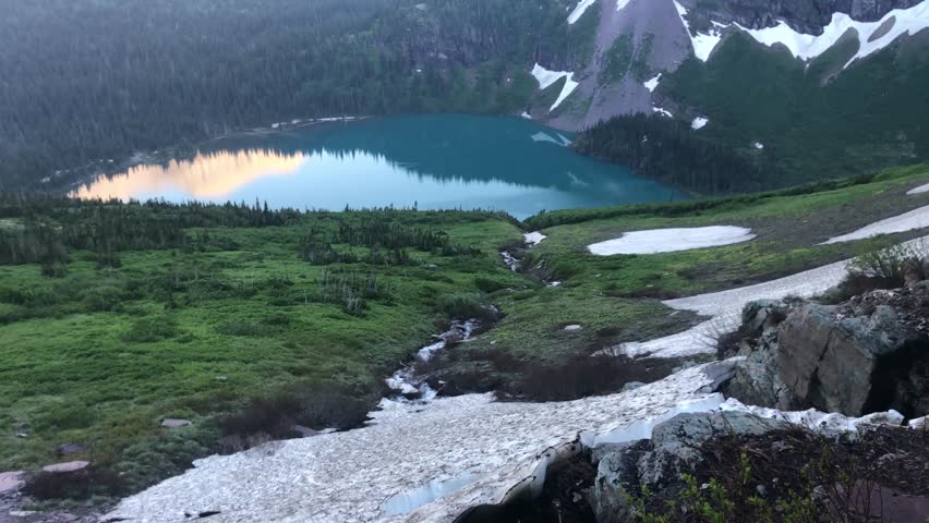 Lake and snowy mountains landscape in Glacier National Park.