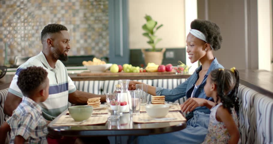 Happy african american family having breakfast, in slow motion. Spending quality time at home concept. | Shutterstock HD Video #1100719697