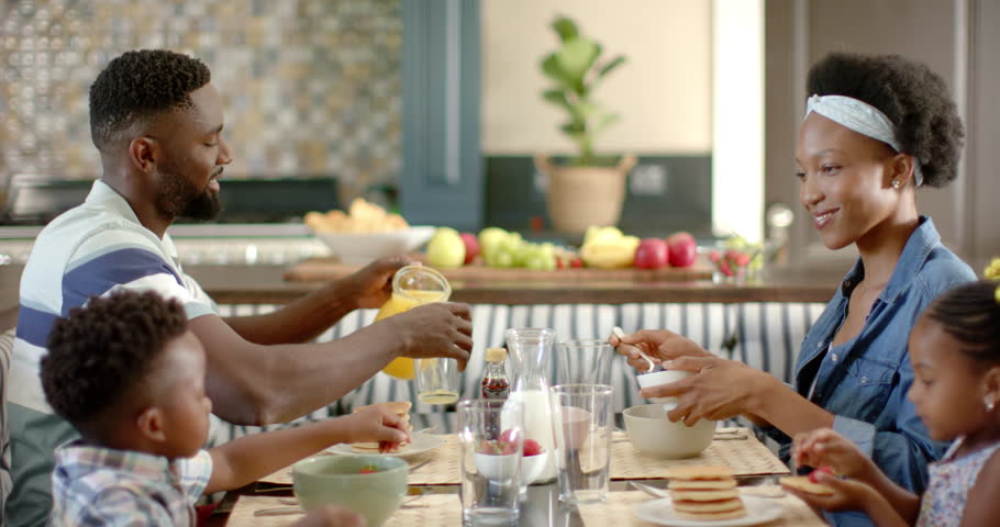 Happy african american family having breakfast, in slow motion. Spending quality time at home concept. | Shutterstock HD Video #1100719701