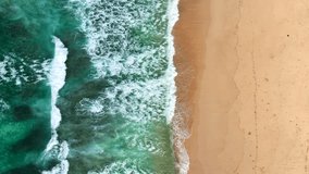 drone video with ocean and white sand beach with above view in 4k