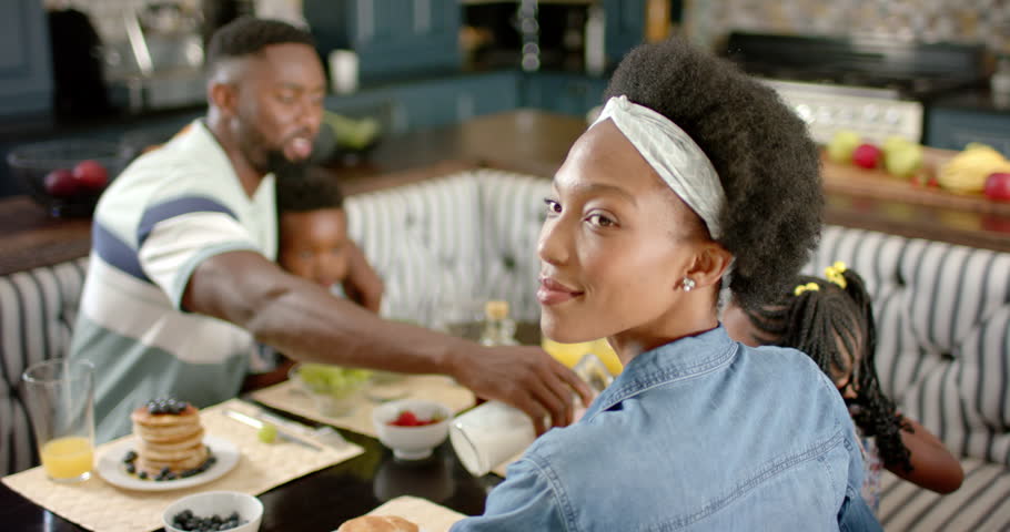 Portrait of happy african american family having breakfast, in slow motion. Spending quality time at home concept. | Shutterstock HD Video #1100719903