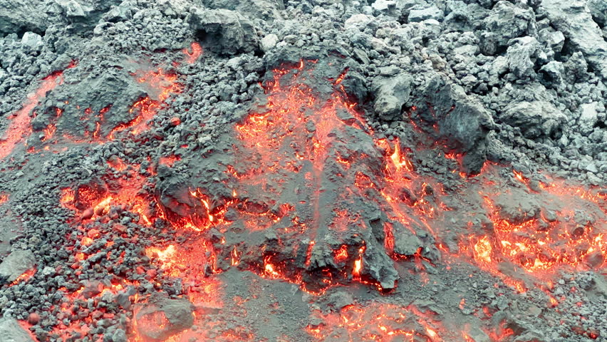 Cinematic steaming red glowing hot lava flow of the Mauna Loa volcano eruption on Hawaii, Big Island in 2022. Shot smartphone camera orange lava and magma flowing down and freezing on black mountain Royalty-Free Stock Footage #1100721211
