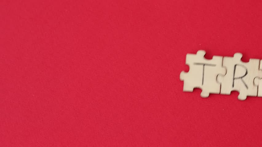 The word TRAUMA written on the puzzles on a red background | Shutterstock HD Video #1100722675