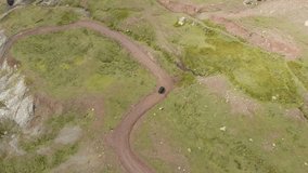 Drone video top view car mountain winding dirt road Gramos Greece summer sunny