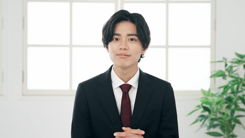 Middle aged Asian businessman talking with video call.