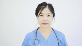 Close-up video of an Asian female nurse wearing a mask.