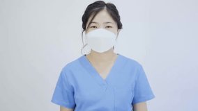 Close-up video of an Asian female doctor wearing gloves properly