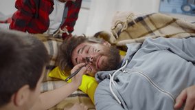 Children paint face of sleeping father. Naughty little boys draw on sleepy dad face. Single father tired babysitting. Mischievous sons paint on father face. Childhood, fatherhood concept. Realtime.  - Powered by Shutterstock - Get 15% off with code: PIKWIZARD15