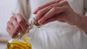 Vegetable oil is poured from a bottle, Cook girl adds sunflower oil to prepared fresh spinach green sauce for making vegan ingredients sauce, Vegan cooking process
 - Powered by Shutterstock - Get 15% off with code: PIKWIZARD15