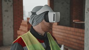 Close-up portrait of modern construction worker wearing VR headset using augmented reality technology at work - Powered by Shutterstock - Get 15% off with code: PIKWIZARD15