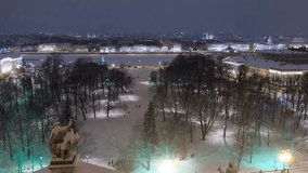 Video from the St. Isaac's Cathedral dome to the Senate Square, Vasilievsky island and Great Neva river under the snow at night. St. Petersburg, Russia