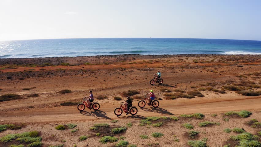 Drone flight over bikers family, Sal Island coast, Cape Verde, Atlantic Ocean, Africa.
