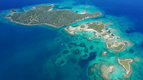 Aerial drone video of tropical exotic volcanic atoll island complex with deep turquoise sea and white sand beaches - Powered by Shutterstock - Get 15% off with code: PIKWIZARD15