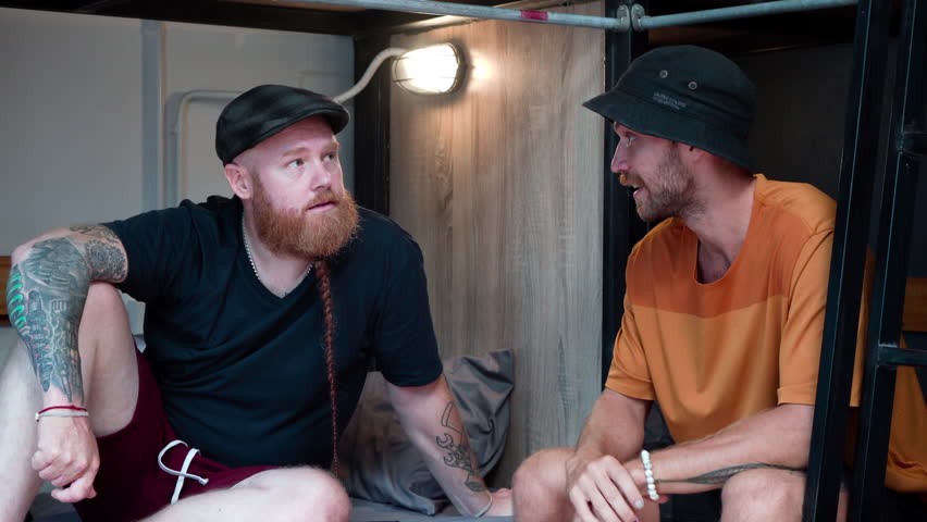 Lifestyle backpacker inexpensive travel for holiday vacation, young Caucasian tourists spend time together after checking in hostel sharing bedroom relax from long trip journey, friendship travel