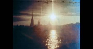 Beautiful sunset on city river. Sun shine with town view. Urban landscape. Golden path on sea water, building silhouettes, panorama. Petersburg 1980s Russia. Vintage archival color film. Retro archive