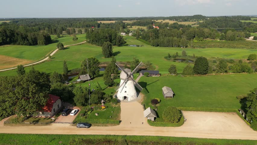 Antique wooden windmill. An old windmills in the countryside. Alternative energy. Wind turbine moving and rotating. Environment friendly concept. Eco farm, green ecological world, wind farm in farmers