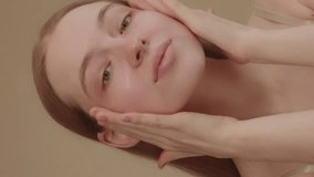 Young lady with blue eyes applies serum to her face, looking into the camera, isolated against a light background Beautiful model girl with perfect clean skin Concept of a skincare or cosmetics ads - Powered by Shutterstock - Get 15% off with code: PIKWIZARD15