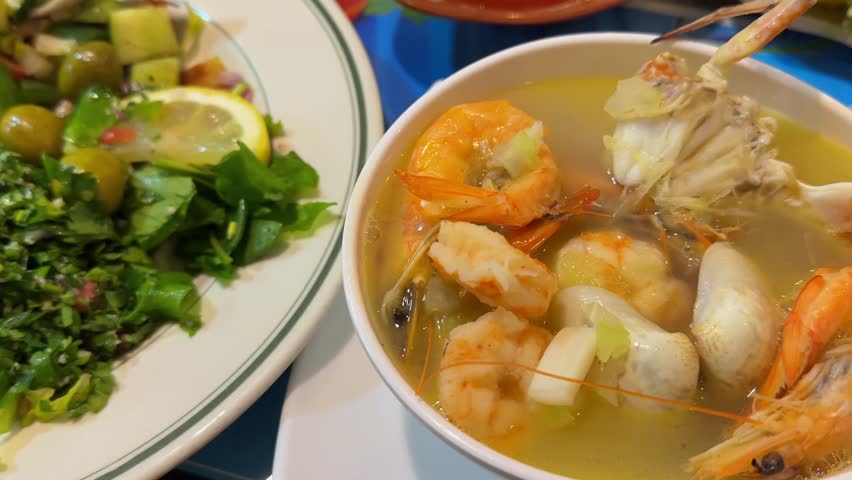 seafood soup in a white cup in a restaurant, shrimp and crab soup. High quality 4k footage