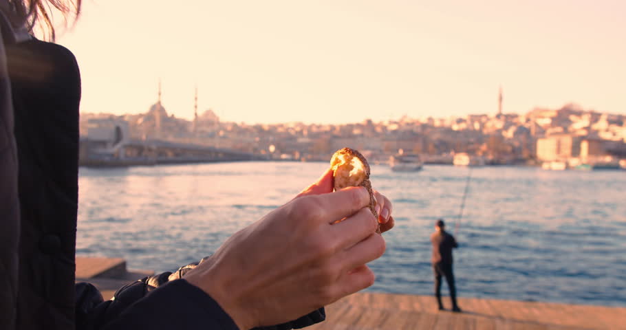 Woman eating simit, turkish bagel with istanbul city view, close-up shot Royalty-Free Stock Footage #1100759113
