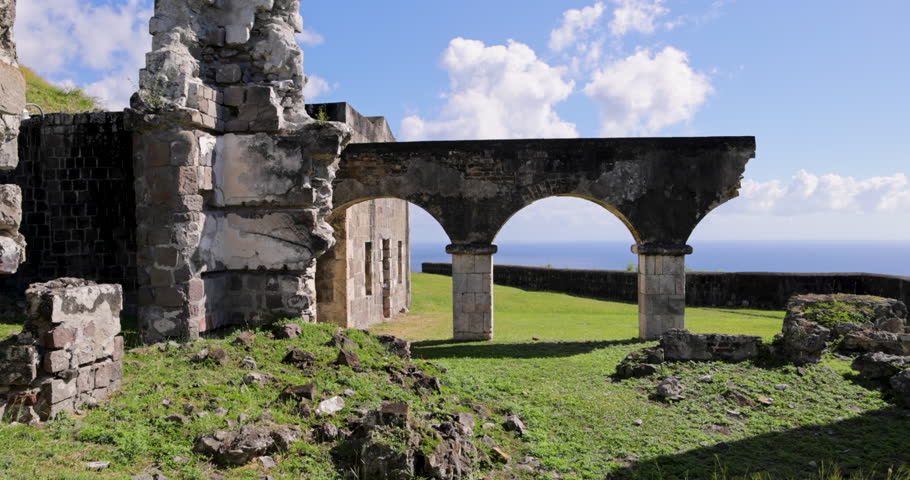 Female tourist explores the ruins of historic Brimstone Hill Fortress a UNESCO national heritage site on the island of St. Kitts