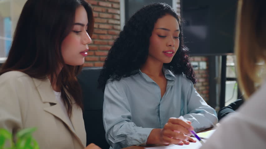 Diversity group of business woman team talking about business plan at modern office. Young business woman present her project with team.