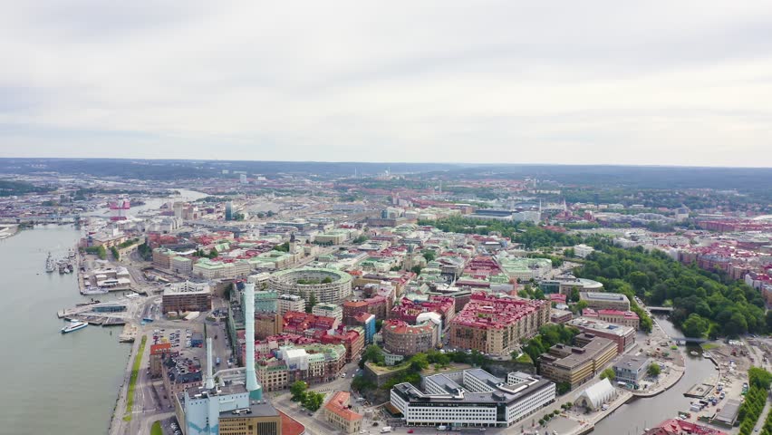 Inscription on video. Gothenburg, Sweden. Panorama of the city and the river Goeta Elv. The historical center of the city. Cloudy weather. Arises from blue water, Aerial View