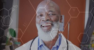 Animation of scientific data processing over senior african american male doctor. Global medicine, computing and data processing concept digitally generated video.