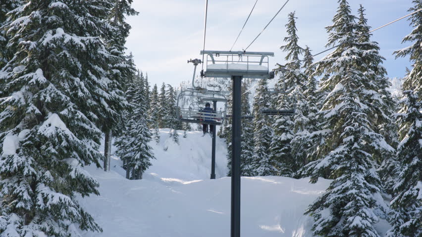 Chairlift Ride at Mountain Winter Sports Resort. Scenic View of Snowy Landscape in Washington State