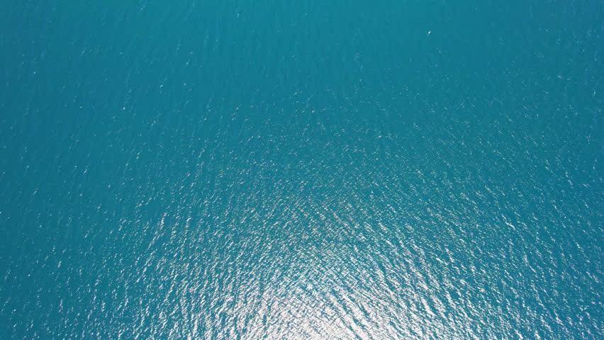 Aerial shot slowly revealing unique sea salt deposits in salt Lagoon close to shoreline of Baja California Sur península, Mexico