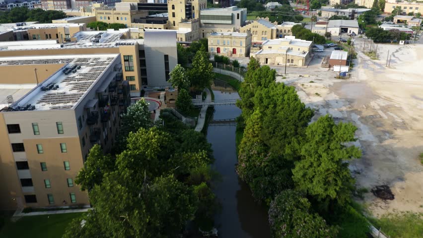 San Antonio Riverwalk aerial flyover and tilt up revealing downtown city skyline in the morning with 4k aerial drone