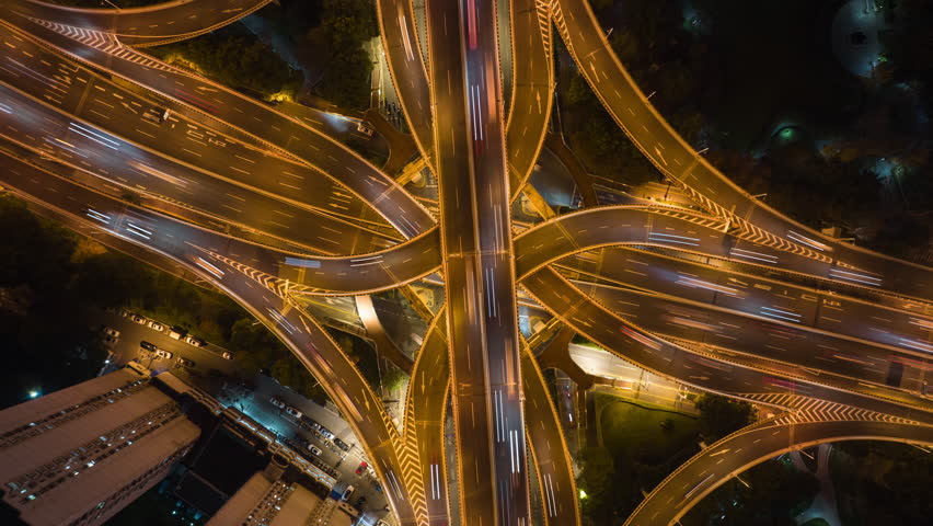 Hyper lapse Rising Drone Shot View Reveals Spectacular Elevated Highway and Convergence of Roads, Bridges, Viaducts in Shanghai Night, Transportation and Infrastructure Development in China Timelapse. Royalty-Free Stock Footage #1100776409