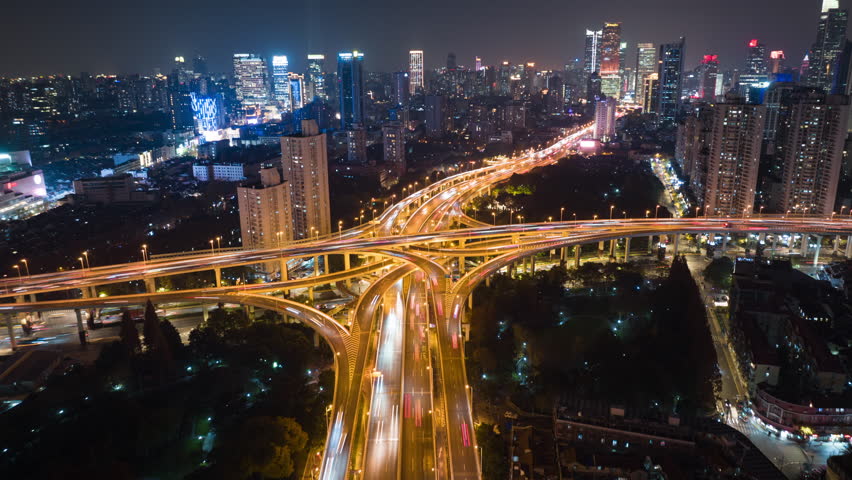 Hyper lapse Rising Drone Shot View Reveals Spectacular Elevated Highway and Convergence of Roads, Bridges, Viaducts in Shanghai Night, Transportation and Infrastructure Development in China Timelapse. | Shutterstock HD Video #1100776411