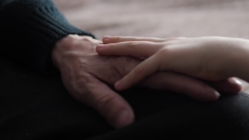 Close-up the child's hand strokes and hugs the wrinkled hands of the grandfather, caring for the guardianship of the elderly, family values, support for loved ones | Shutterstock HD Video #1100778535