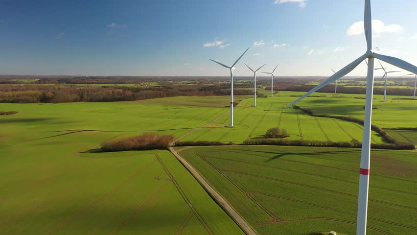 Aerial flying over renewable energy wind farm. Landscape with wind turbines in countryside. Agricultural fields on eco farm modern electric station renewable energy.  Royalty-Free Stock Footage #1100779031