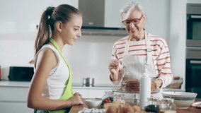 Video of happy family grandmother and granddaughter making chocolate cake in the kitchen - Powered by Shutterstock - Get 15% off with code: PIKWIZARD15