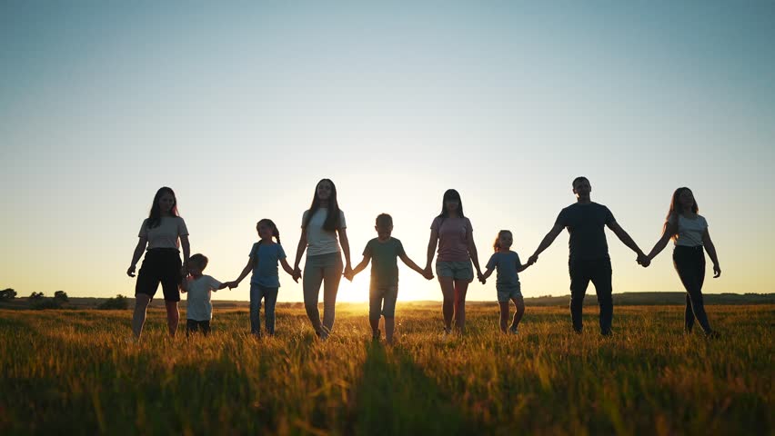 People in the park. big family silhouette walk at sunset. mom dad and daughters walk holding hands in the park. big family kid dream concept. parents and fun children walking back silhouette | Shutterstock HD Video #1100784269