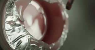 soaking bones in a jar of pink gel nail polish. manicure in a beauty salon. macro. vertical video