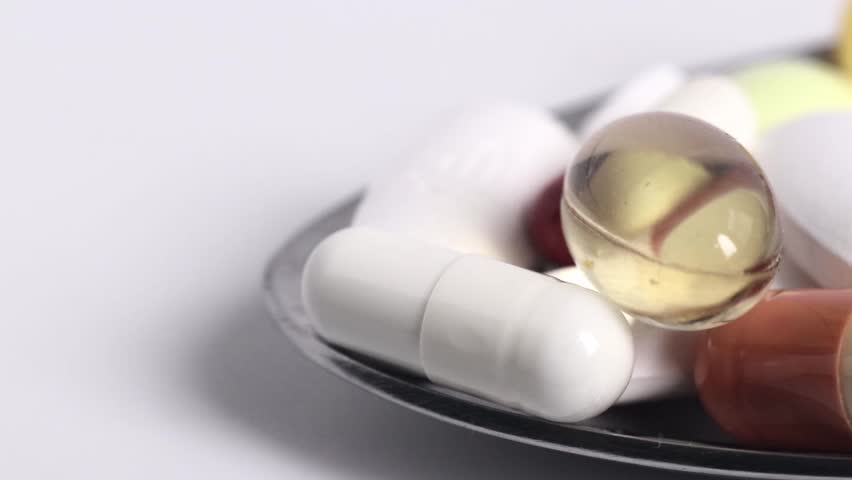 Macro video of Medicinal Medicines piled in a metal spoon. Stock video.