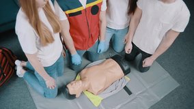 First aid resuscitation, CPR training. Students study in front of a dummy - Powered by Shutterstock - Get 15% off with code: PIKWIZARD15