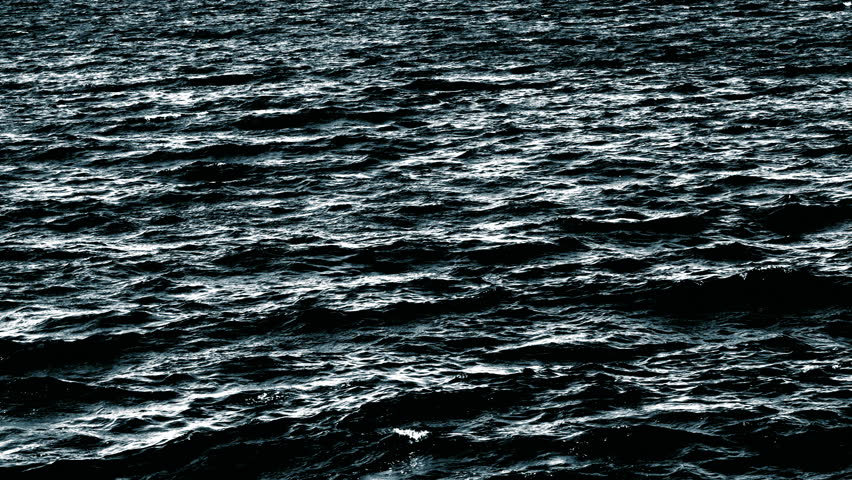 Slow motion video of dark water surface with waves