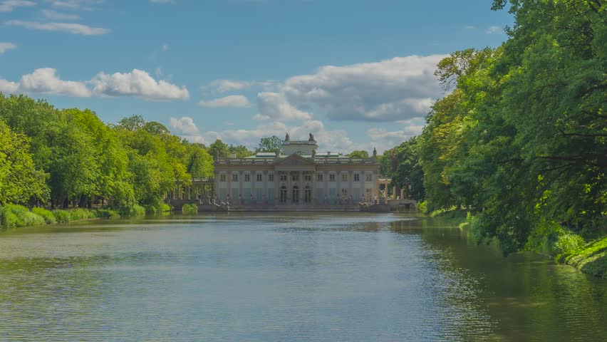 Summer day view time lapse of еhe Palace on the Isle (Polish: Pałac Na Wyspie), also known as Baths Palace (Polish: Pałac Łazienkowski) Łazienki Park or Royal Baths Park. Landmark of Poland.