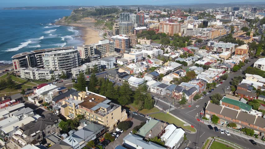 Aerial drone shot descending over the harbour city of Newcastle, NSW, Australia on a sunny day 