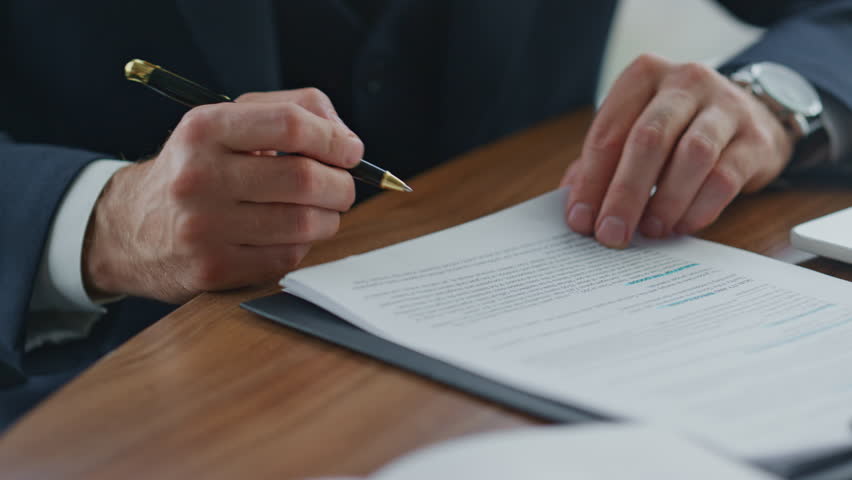 Unrecognizable businessman signing official documents by pen close up. Man hands putting signature on business contract partnership agreement commercial papers. Office manager working with paperwork. Royalty-Free Stock Footage #1100805703