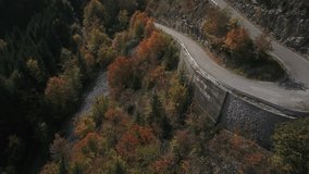 Hairpins of Plateau des Glières in Haute-Savoie during autumnal foliage, France. Aerial top-down forward