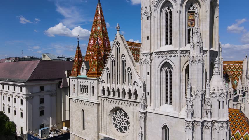 Closeup of Matthias Church Bell tower. Drone flying upwards revealing stunning Budapest panorama